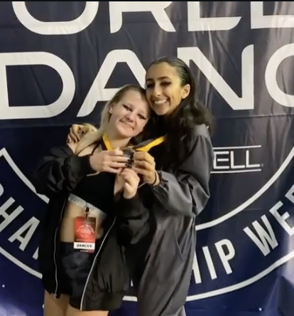 Showing off medals at World of Dance