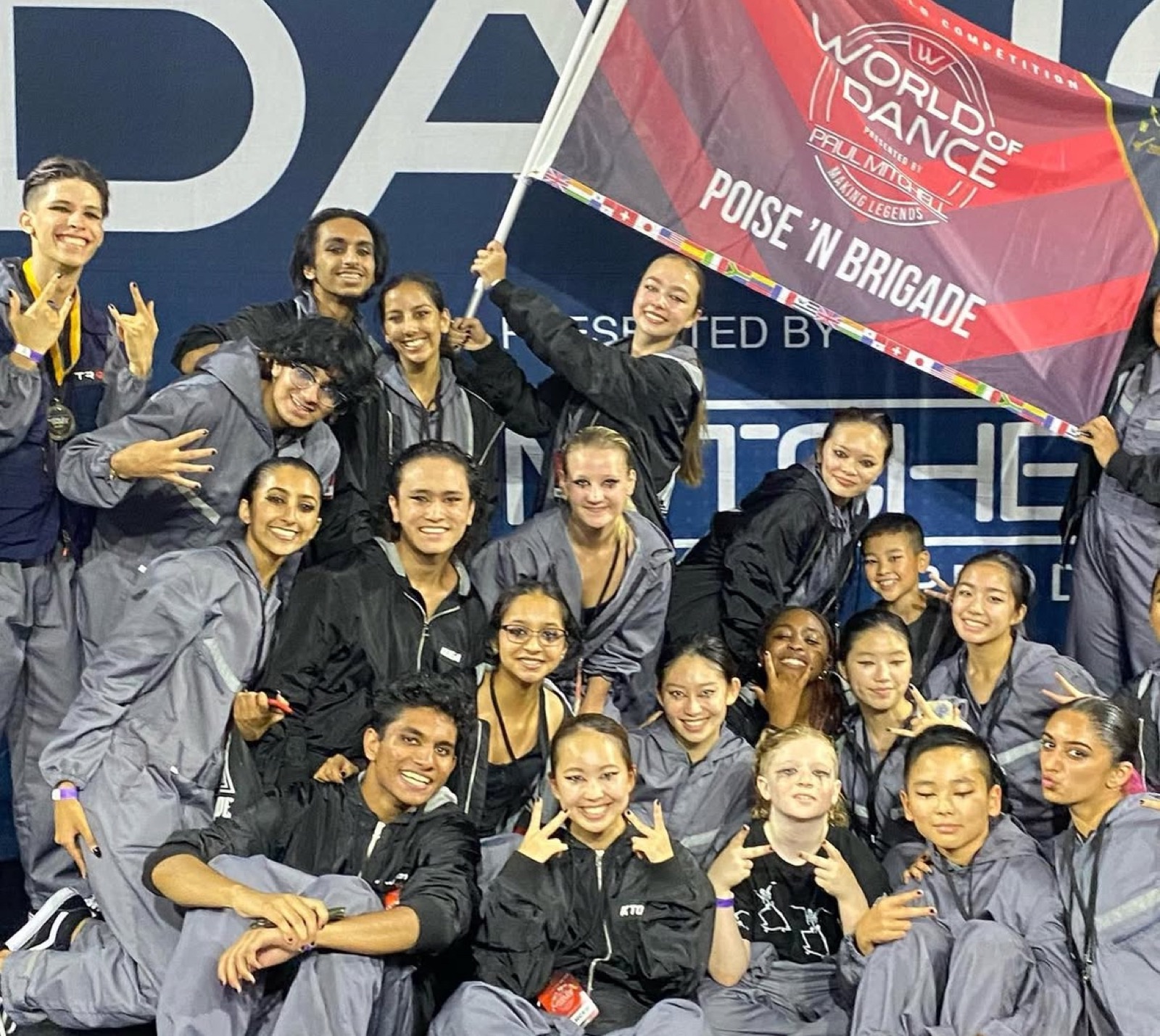 Poise 'N Brigade holding the team flag at World of Dance Championship Week